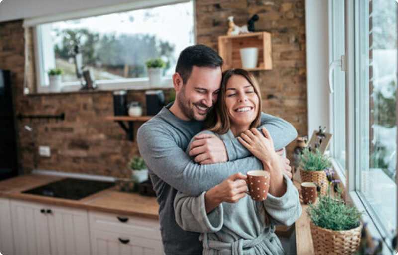 Man hugging woman in the kitchen